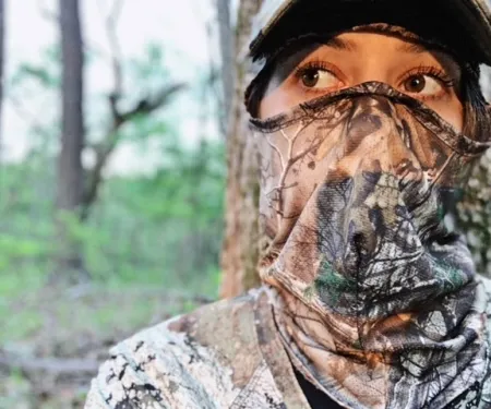 Hunter in the field with camo face cover.