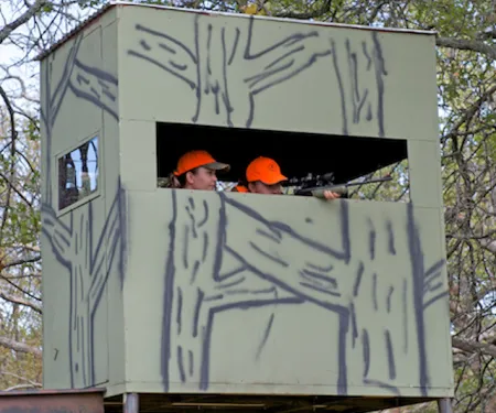 Youth and adult in hunting blind.