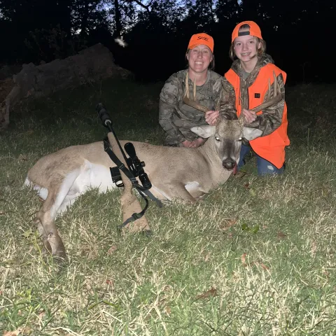 girl and guardian with harvested buck