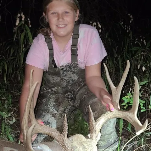 Young female hunter pictured with harvested deer.