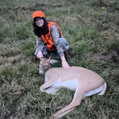 Young hunter pictured with harvested deer.