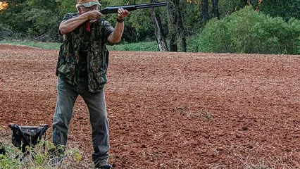 Man in field dove hunting.