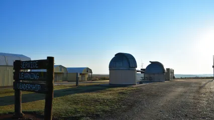 A series of structures with a sign for the Selman Living Lab in northwestern Oklahoma. 