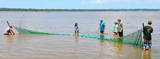 Teens learn about using nets for sampling fish populations during last year's Wildlife Youth Camp at Lake Texoma. Campers get hands-on experience learning about wildlife and fisheries conservation and law enforcement during the six-day event.  (DON P. BROWN / ODWC)