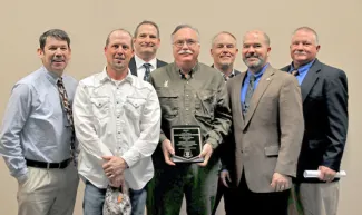ODWC 2017 Landowner Conservation of the Year Award winner Walter D. Haskins in the middle surrounded by ODWC staff.
