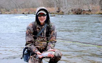 Man holding rainbow trout.