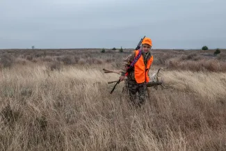 Youth hunter in orange with deer at Packsaddle WMA, photo by Kelly Adams