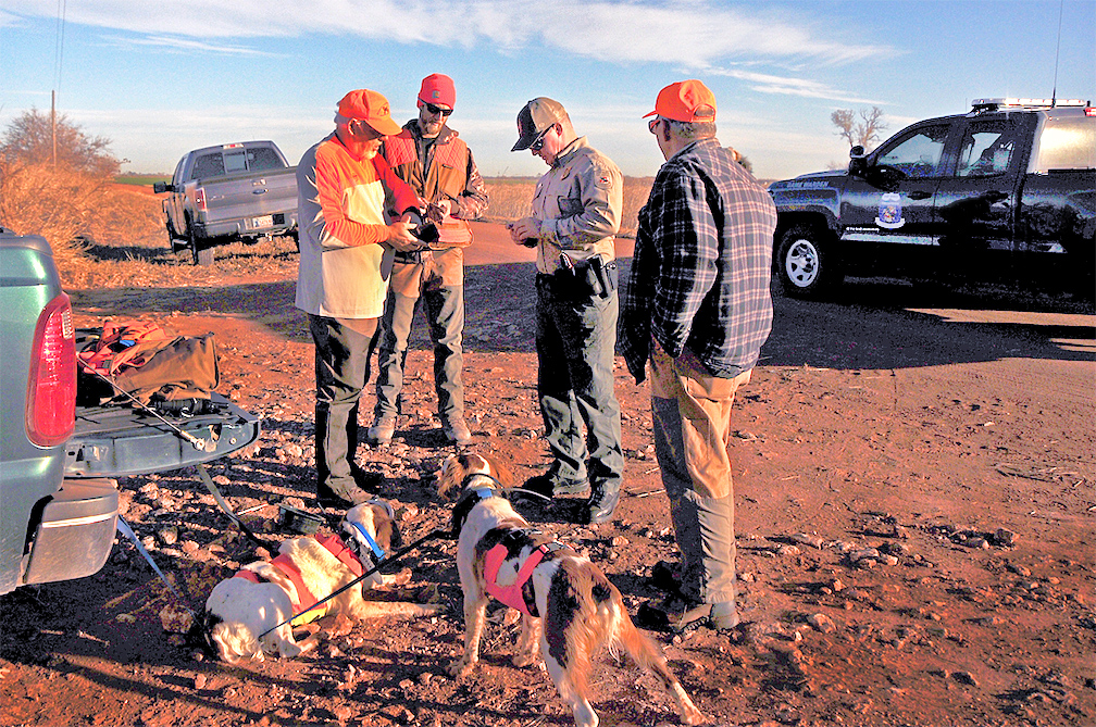 Game warden checking license in the field.  (DON P. BROWN/ODWC)
