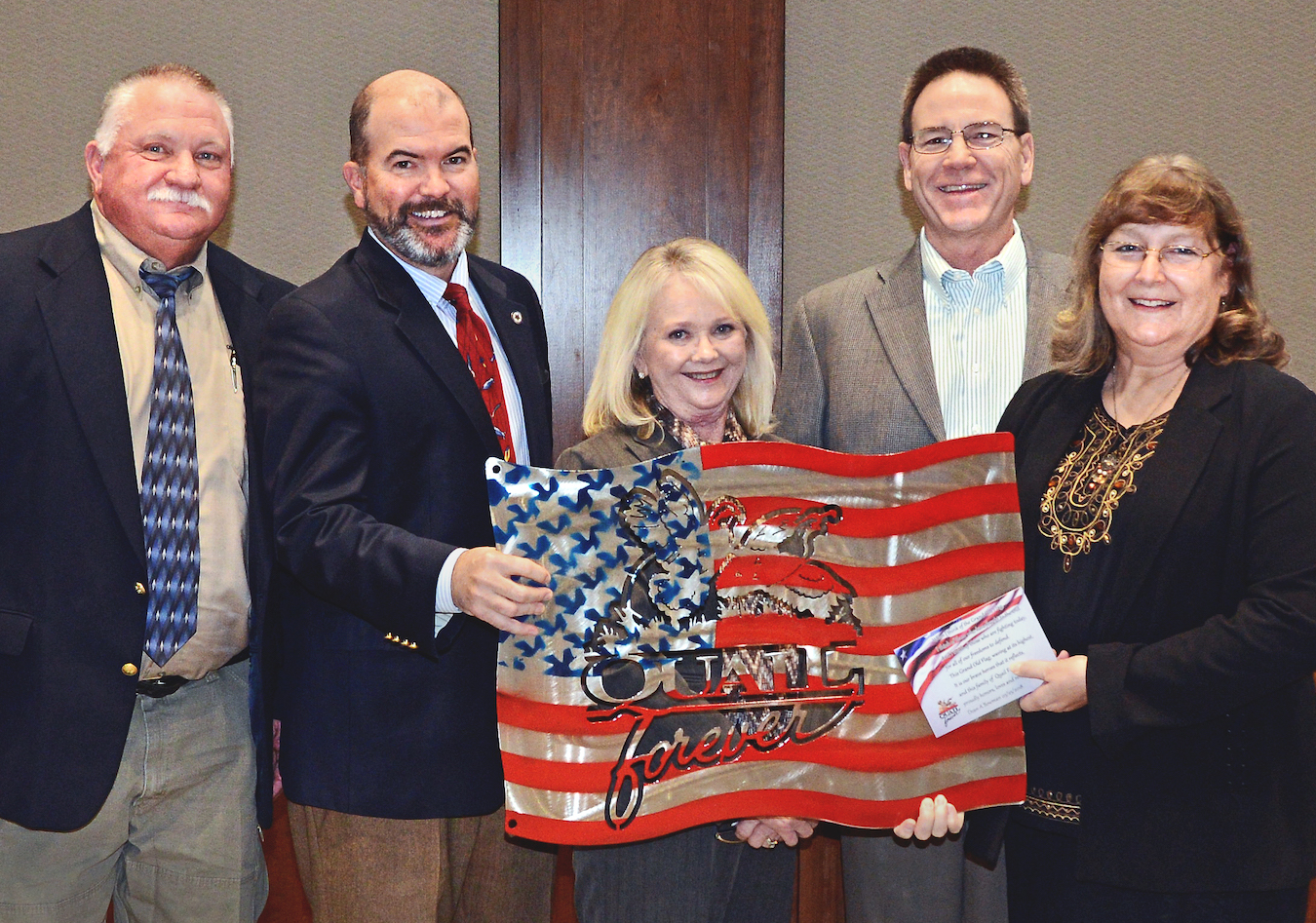 Presenting metal artwork used to raise funds for the Wildlife Department's Stars &amp; Stripes License Project are, from left, Department Wildlife Chief Alan Peoples, Department Director J.D. Strong, Department Assistant Director Melinda Streich, James Dietsch and Laura McIver, both of Quail Forever. (Don P. Brown/ODWC)