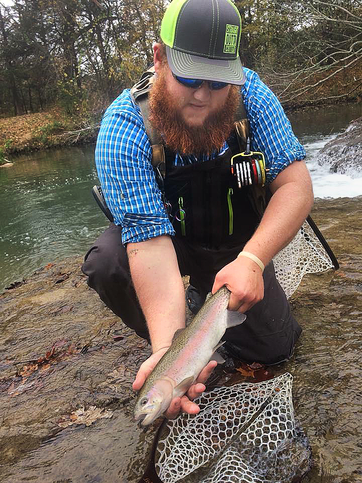 Angler Woodrow Barnes holds a rainbow trout he caught at the Blue River Public Fishing and Hunting Area last year. Trout stocking will begin by Nov. 1 at six seasonal fishing areas across the state. (Doron Lovett via Facebook)