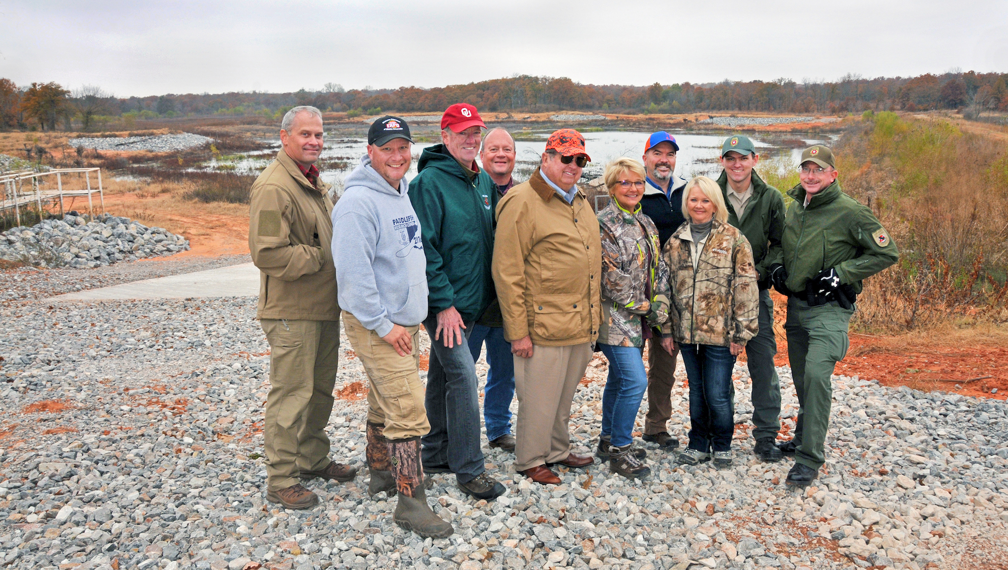 Viewing renovations at Dahlgren Lake are, from left, Law Assistant Chief Nathan Erdman, Fisheries Research Supervisor Kurt Kuklinski, Fisheries Chief Barry Bolton, Fisheries Assistant Chief Ken Cunningham, Commissioner John Groendyke, Commissioner Leigh Gaddis, ODWC Director J.D. Strong, Assistant Director Melinda Streich, Game Warden Tell Judkins and Game Warden Brian Meskimen. (Don P. Brown/ODWC)