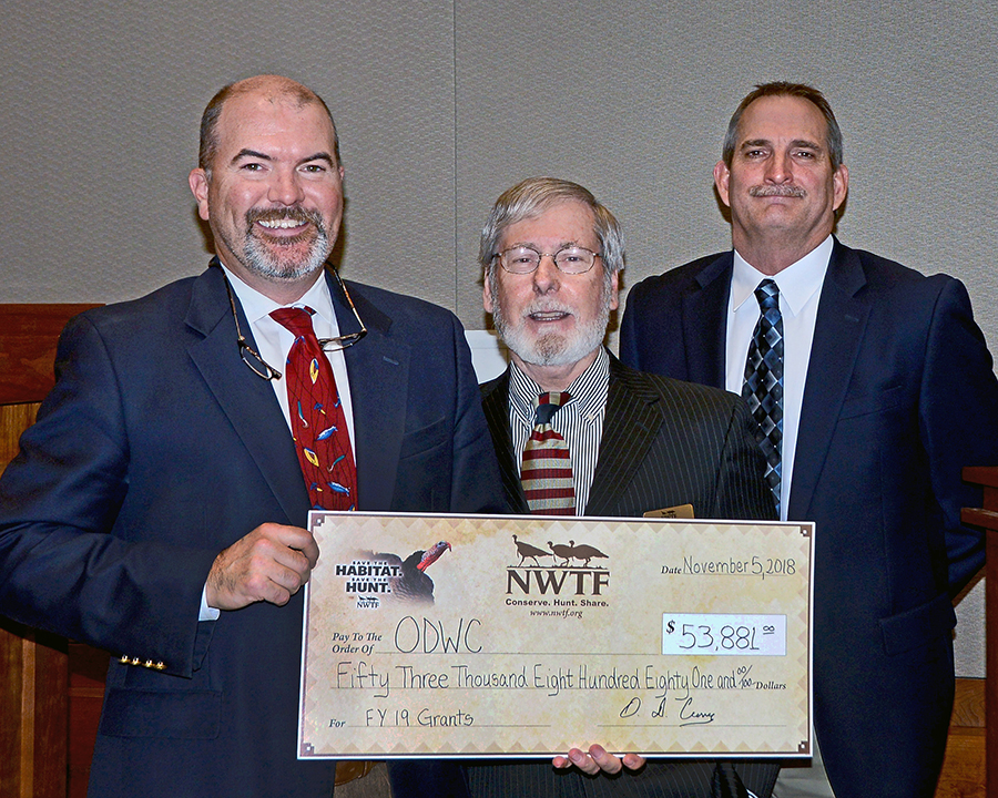 NWTF Oklahoma President O.D. Curry, center, presents a $53,881 donation to Wildlife Department Director J.D. Strong and Assistant Chief of Wildlife Bill Dinkines. (Don P. Brown/ODWC)