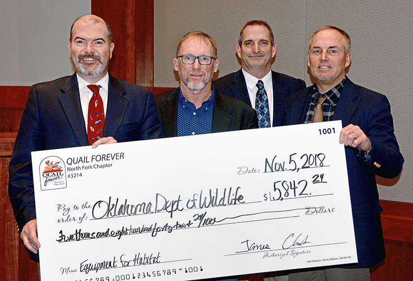 Accepting a $5,842.24 donation from North Fork Quail Forever Chapter President Jimmy Clark, second from left, are Wildlife Department Director J.D. Strong, Assistant Chief of Wildlife Bill Dinkines, and Assistant Director Wade Free. (Don P. Brown/ODWC)