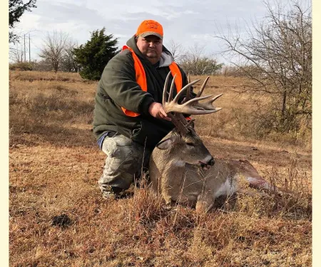 Louise Nottingham in field with harvested buck.