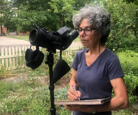 Woman looking through scope.