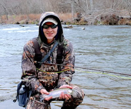 Man holding rainbow trout.