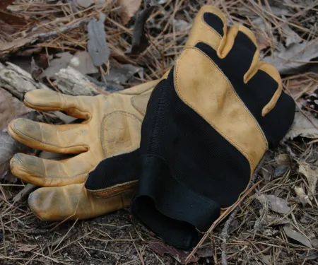 a pair of leather and black fabric gloves