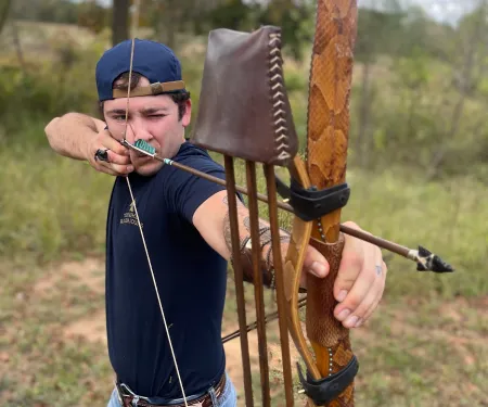 A man draws a bow with an arrow