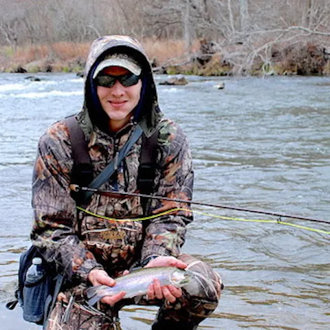 Man holding rainbow trout.