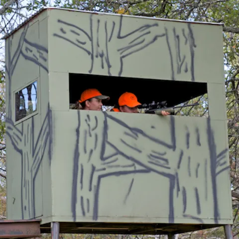 Youth and adult in hunting blind.