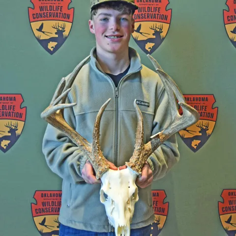 hunter bishop holding a deer rack
