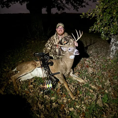 man with archery buck