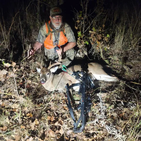 man with archery buck