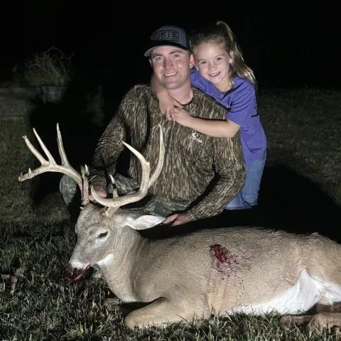 dad and daughter with buck