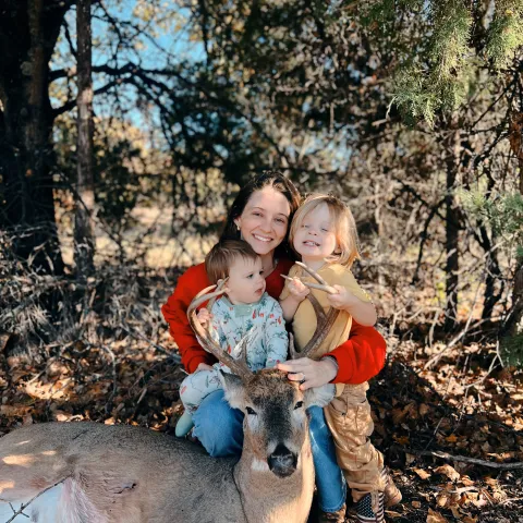 mom with archery buck and 2 sons