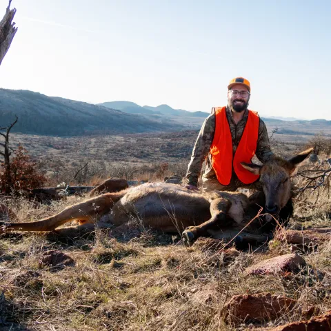man with cow elk