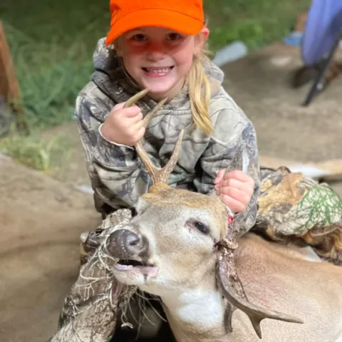 Wrenly Collins with her harvested Oklahoma whitetail deer.