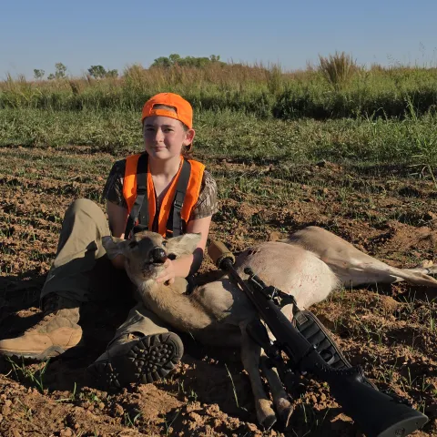 Kinsley Bishop with her harvested Oklahoma White-tailed deer.