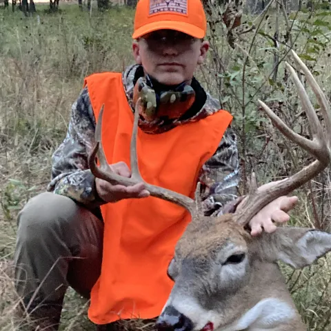 boy with harvested buck