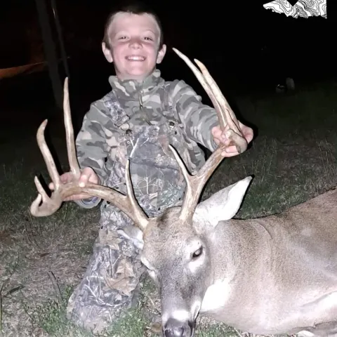 Trigger Johnson with his harvested buck taken with a crossbow in 2023.