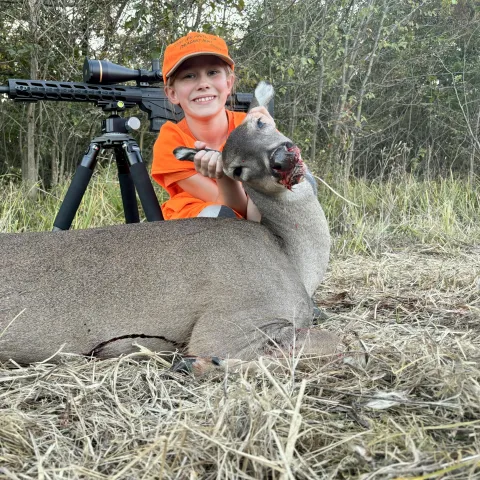 Young hunter pictured with harvested deer.
