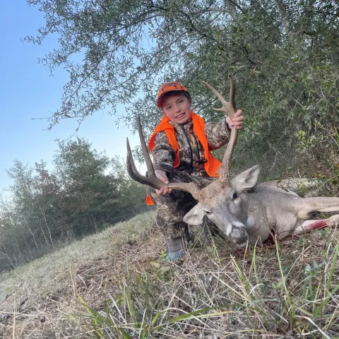 boy with harvested buck