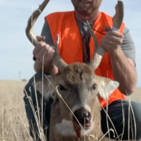 Hunter pictured with harvested deer.