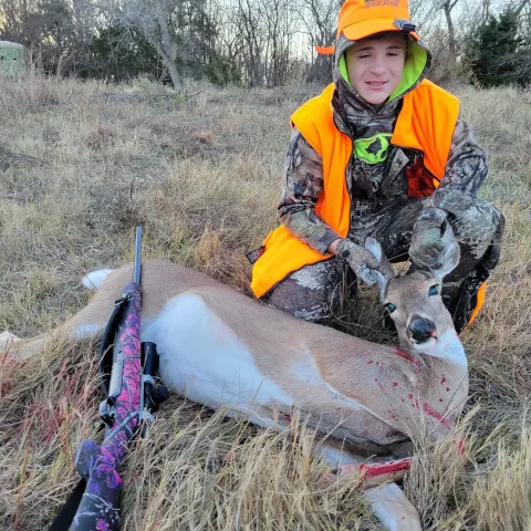 Youth hunter with deer.