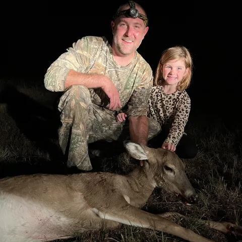 Youth hunter with deer.