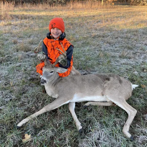 Youth hunter with deer.