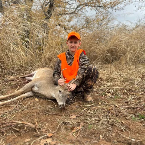Youth hunter with deer.
