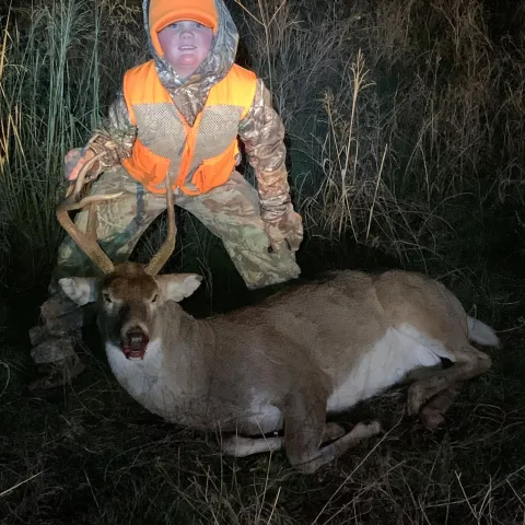 boy with harvested buck