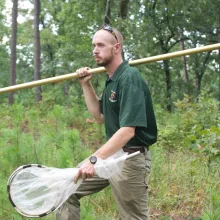 Biologist in the field at McCurtain County Wilderness Area with net.