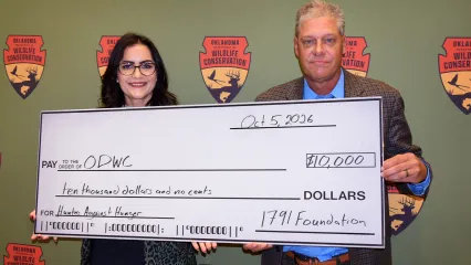 woman and man holding large check