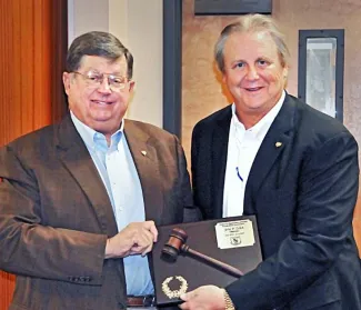 Incoming Commission Chairman John Groendyke presents an award of appreciation to Commissioner John Zelbst for his service as chairman from 2013-17.   (DON P. BROWN/ODWC)