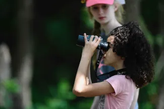 Girl with binoculars birdwatching 