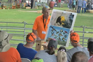 Fish biologist helping teach bird identification at Wildlife EXPO.