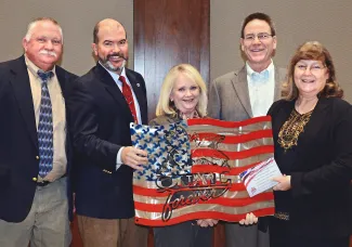 Presenting metal artwork used to raise funds for the Wildlife Department's Stars &amp; Stripes License Project are, from left, Department Wildlife Chief Alan Peoples, Department Director J.D. Strong, Department Assistant Director Melinda Streich, James Dietsch and Laura McIver, both of Quail Forever. (Don P. Brown/ODWC)