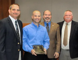Gathered for the 2018 wildlife biologist of the year award presentation are, from left, Wildlife Assistant Chief Bill Dinkines, award winner Matt Mattoida, Department Director J.D. Strong, and Wildlife Chief Alan Peoples. (Don P. Brown/ODWC)