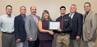 Presenting the National Bobwhite Conservation Initiative's 2017 Fire Bird Conservation Award for Oklahoma are, from left, James Dietsch of Central Oklahoma 89er Chapter of Quail Forever; Wildlife Department Assistant Director Wade Free; Department Director J.D. Strong; honoree Laura McIver, regional representative, Oklahoma and Texas Quail Forever; Derek Wiley, Department upland game biologist; Wildlife Division Chief Alan Peoples; and Wildlife Division Assistant Chief Bill Dinkines. (Don P. Brown/ODWC)